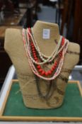 Various necklaces on a jewellery bust.