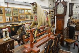 A good painted rocking horse on wooden stand.