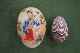 Two decorative hardstone eggs.
