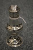 A silver baluster shaped pepperette.