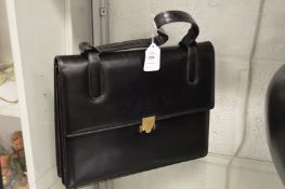 An Asprey black leather handbag.