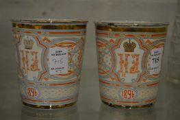 A pair of enamel commemorative beakers.