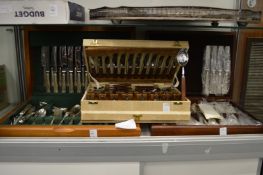 Three canteens of cutlery.