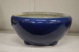 A Chinese blue ground circular bowl on moulded feet (cracked).