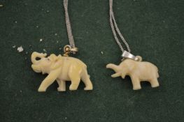 Two elephant pendants.