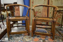 A pair of Chinese horseshoe shaped armchairs.