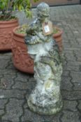 A small composite garden ornament modelled as a young lady holding a basket.