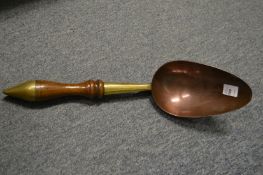 A 19th century brass, copper and turned wood powder scoop.