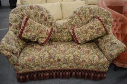 A decoratively upholstered Victorian spoon back settee.