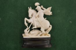 A carved ivory George and the Dragon.