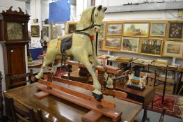 A good painted rocking horse on wooden stand.