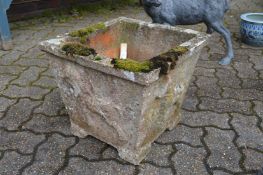 A small composite square shaped garden planter.