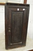 An old oak hanging corner cupboard.