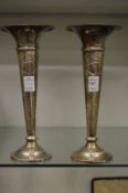 A pair of silver trumpet shaped vases.