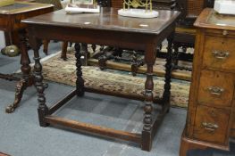 An oak side table with turned supports.