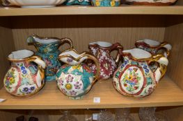 A quantity of colourful Belgian pottery jugs.