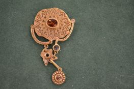 A Patricia Locke designer gilt brooch.