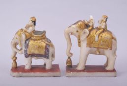 A PAIR OF 19TH CENTURY INDIAN CARVED POLYCHROME ALABASTER ELEPHANTS AND RIDERS, (one with damage),
