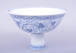 A CHINESE BLUE AND WHITE MING STYLE PORCELAIN STEM CUP, painted with scrolling foliate decoration,