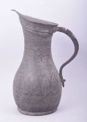 AN ISLAMIC ENGRAVED METAL EWER, 30cm high.