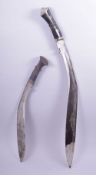 TWO LARGE NEPALESE KUKRI KNIVES, one in leather sheath, 76cm long and 52cm long.
