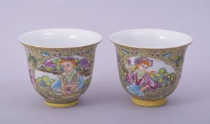 A PAIR CHINESE / EUROPEAN FAMILLE JAUNE PORCELAIN CUPS, decorated with panels of figures, each