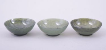 A FINE SET OF THREE CHINESE JADE CUPS, in fitted box, each 7cm diameter.