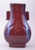 A CHINESE FLAMBE TWIN HANDLE VASE, the base with four character mark, 28cm high.