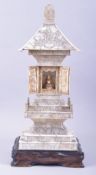 A CHINESE CARVED IVORY TEMPLE / PAGODA SHRINE, the central section with doors opening to reveal a