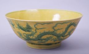 A CHINESE YELLOW GROUND PORCELAIN DRAGON BOWL, with incised green dragons and clouds to the