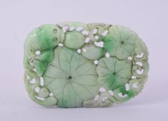 A CHINESE CARVED AND PIERCED JADE / JADEITE AMULET, with carp and lily pads, 9cm x 6cm.