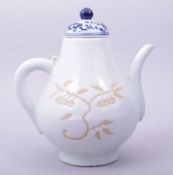 A CHINESE MING STYLE BLUE AND WHITE PORCELAIN WINE JAR AND COVER, decorated with unglazed