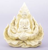 A LARGE BLANC DE CHINE PORCELAIN GUANYIN SITTING ON A LOTUS, the reverse with two marks, 32cm high.