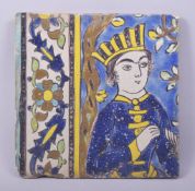 A PERSIAN SAFAVID CUERDA SECA SINGLE POTTERY TILE, the section painted with a male figure with a