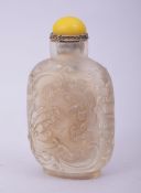 A CHINESE CUT GLASS SNUFF BOTTLE AND STOPPER, decorated with chilong, the base with four character