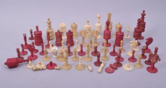 A QUANTITY OF CARVED IVORY CHESS PIECES, including a quantity of stained red pieces.