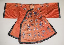 A CHINESE CORAL GROUND EMROIDERED SILK JACKET, embroidered with floral design.