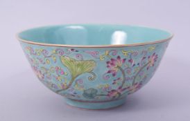 A CHINESE TURQUOISE GROUND FAMILLE ROSE PORCELAIN BOWL, the exterior decorated with flora, with