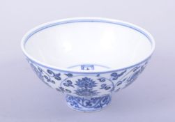 A CHINESE BLUE AND WHITE PORCELAIN BOWL, the exterior painted with lotus, the interior baring a