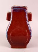 A CHINESE FLAMBE GLAZED PORCELAIN TWIN HANDLE VASE, 30cm.