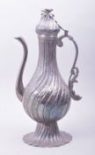 A 19TH CENTURY TURKISH LIDDED SILVER COFFEE POT, the lid with bird finial, 35.5cm high.