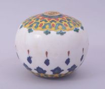 A TURKISH OTTOMAN KUTAHYA GLAZED POTTERY HANGING BALL / ORNAMENT, approx 13cm diameter.