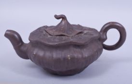 A CHINESE YIXING NATURALISTIC FORM TEAPOT AND COVER, with impressed mark to inner lid and base, 18cm