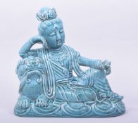 A CHINESE SONG STYLE TURQUOISE GLAZED GUANYIN AND LION FIGURE, with mark to base, 25cm long.