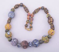 A MIDDLE EASTERN BEADED NECKLACE.