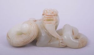 A CHINESE JADE CARVING of a lion dog and serpent, 8.5cm long.