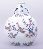A CHINESE MING STYLE UNDERGLAZE RED AND BLUE TWIN HANDLE MOON FLASK, the body decorated with birds