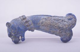 AN ISLAMIC CARVED LAPIS LAZULI DAGGER HILT, carved in the form of tiger head with floral decoration,