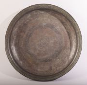 A LARGE 17TH CENTURY PERSIAN SAFAVID BRONZE DISH, with engraved decoration, the centre with a