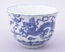 A CHINESE BLUE AND WHITE PETAL SHAPE BOWL, the exterior painted with dragons amongst stylised